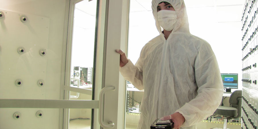 Entering ISO 5 / Class 100 certified data recovery cleanroom air shower unit to get rid of dust on body before entering work stations